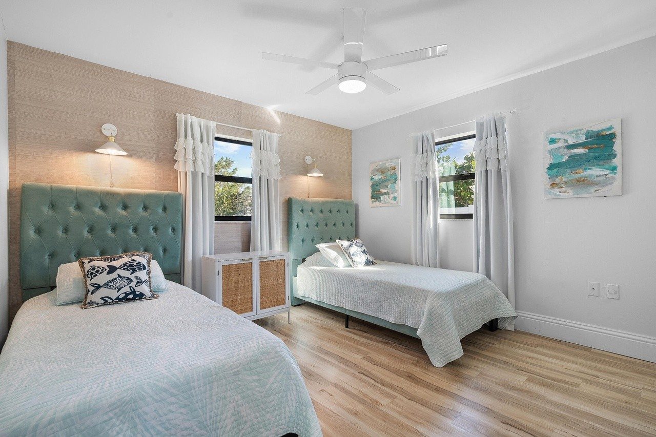 Bedroom with two twin beds and coastal blue headboards